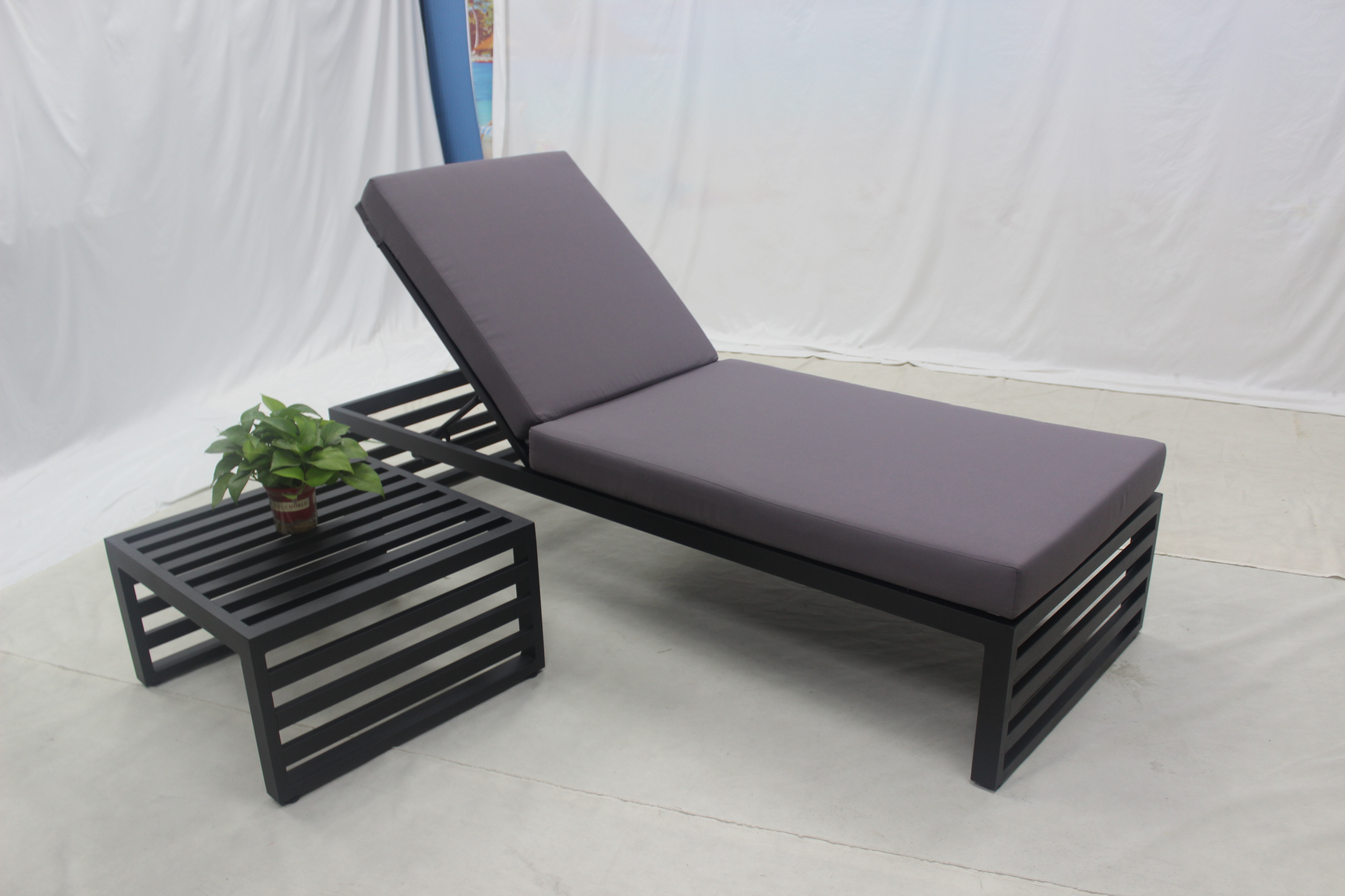Black aluminum outdoor single lounge sunbed with purple cushion