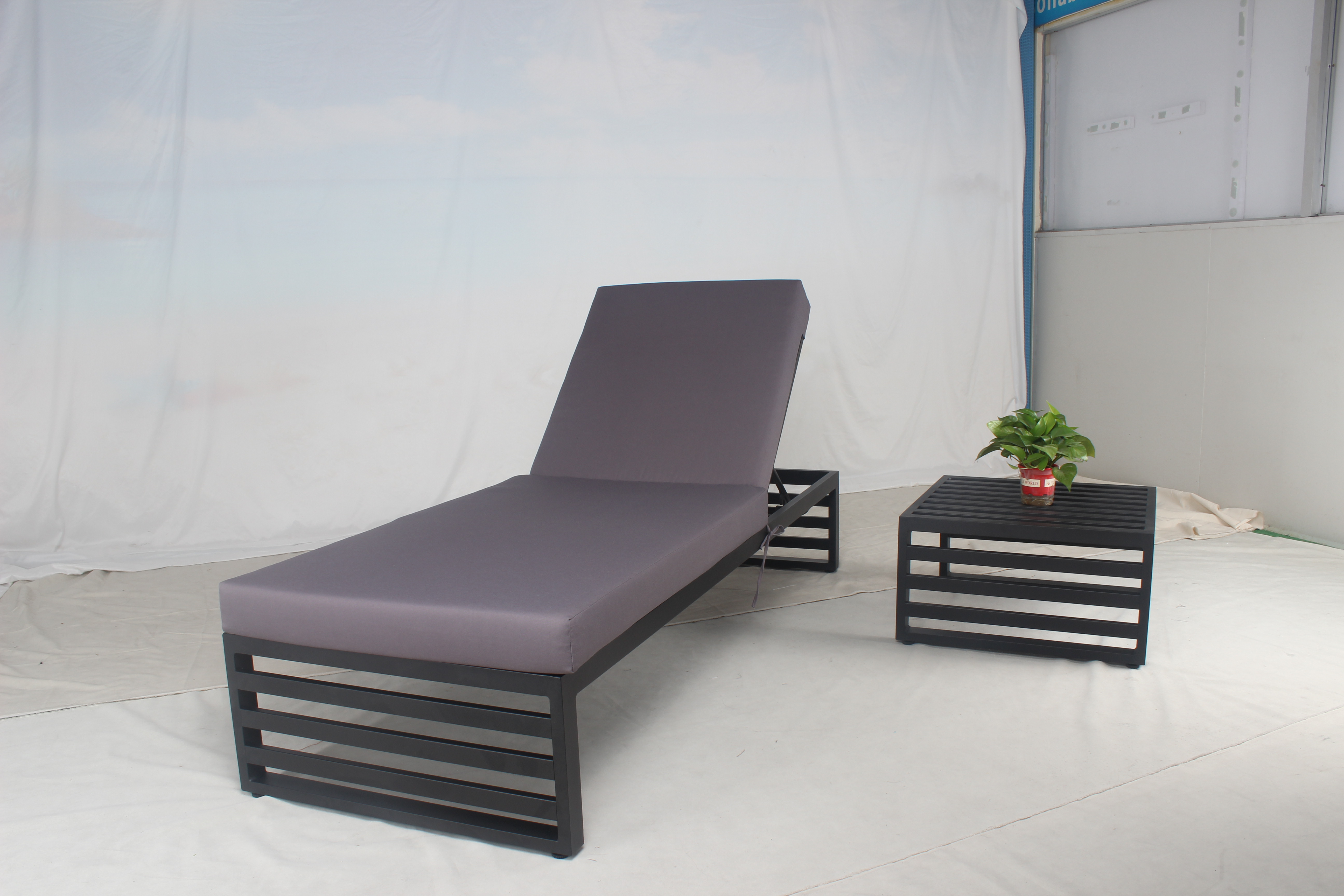 Black aluminum outdoor single lounge sunbed with purple cushion